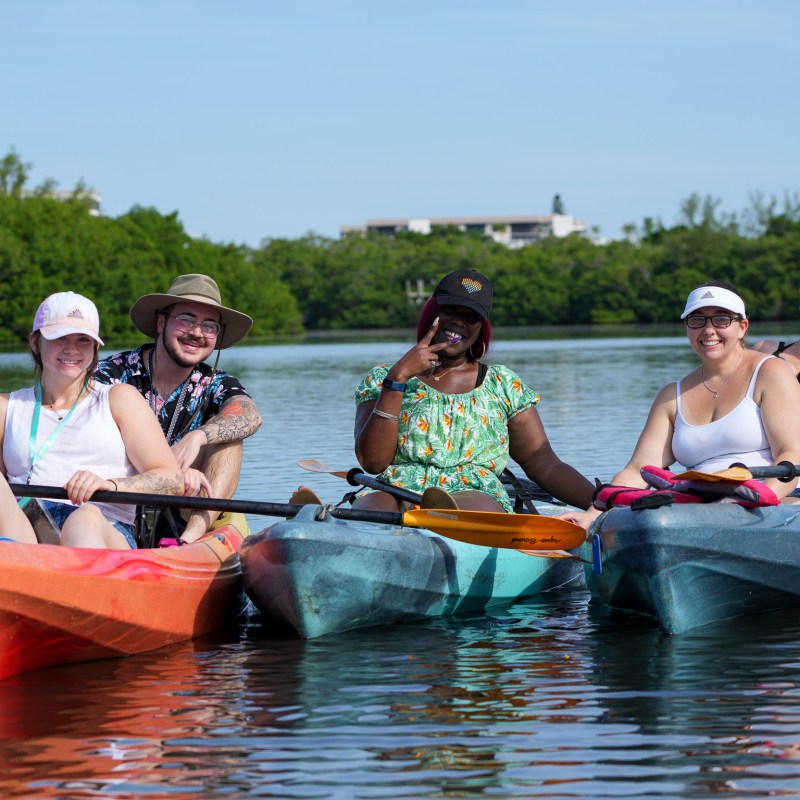 a group of people riding on the back of a boat