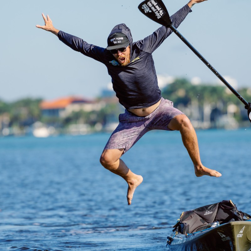 a man jumping in the air over a body of water