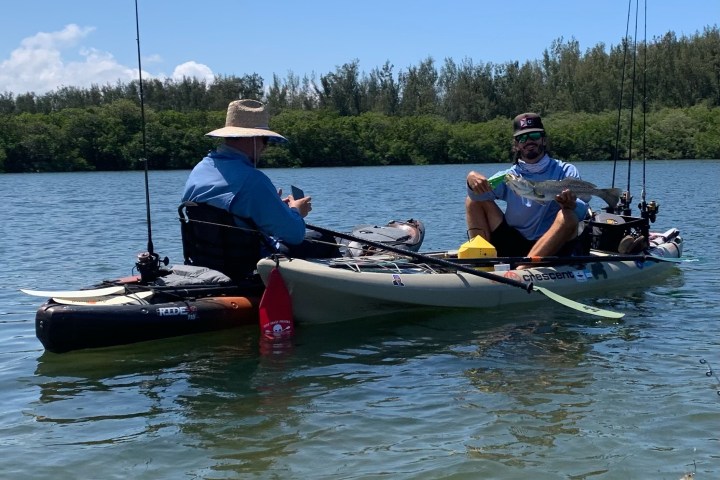 a group of people rowing a boat in the water