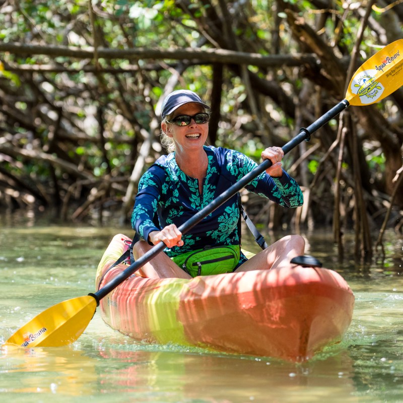 a person riding on the back of a boat in the water